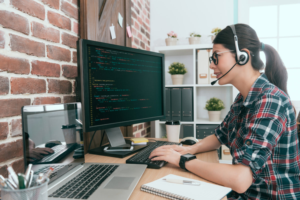 Woman with headphones working on computer