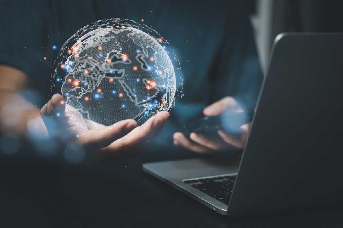 Businessman holding digital world globe