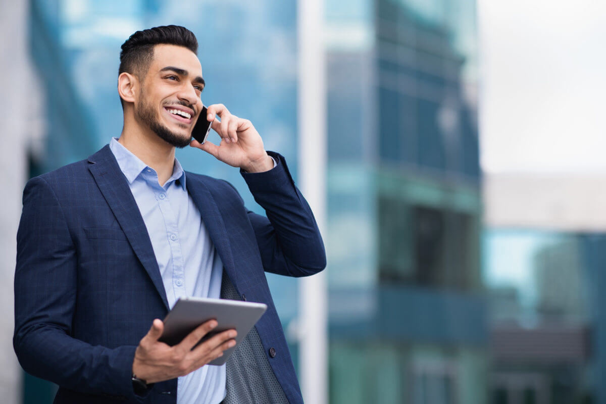 Businessman on mobile phone holding a tablet